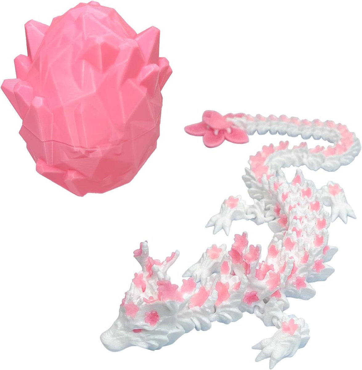 Articulated 3D printed dragon posed beside its crystal egg shell